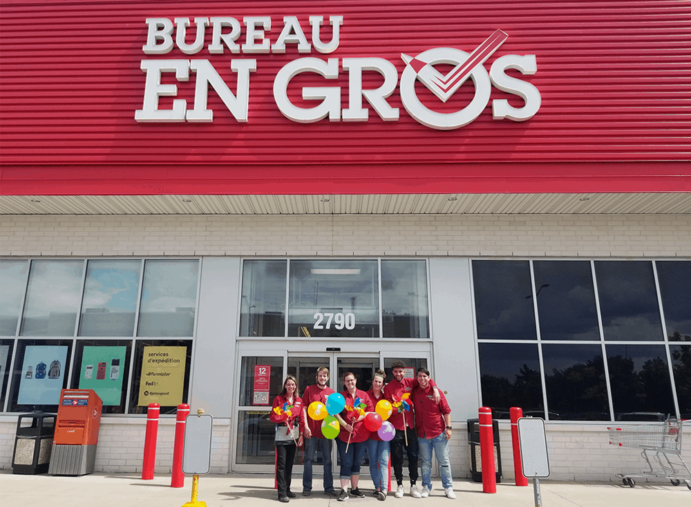 Bureau En Gros employees standing in front of their store