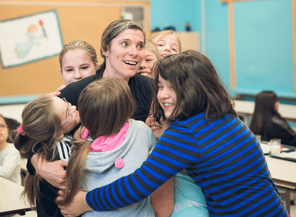 Children hugging a woman
